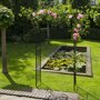Metalen rozenboog 'New Dawn' begroeid met rozen